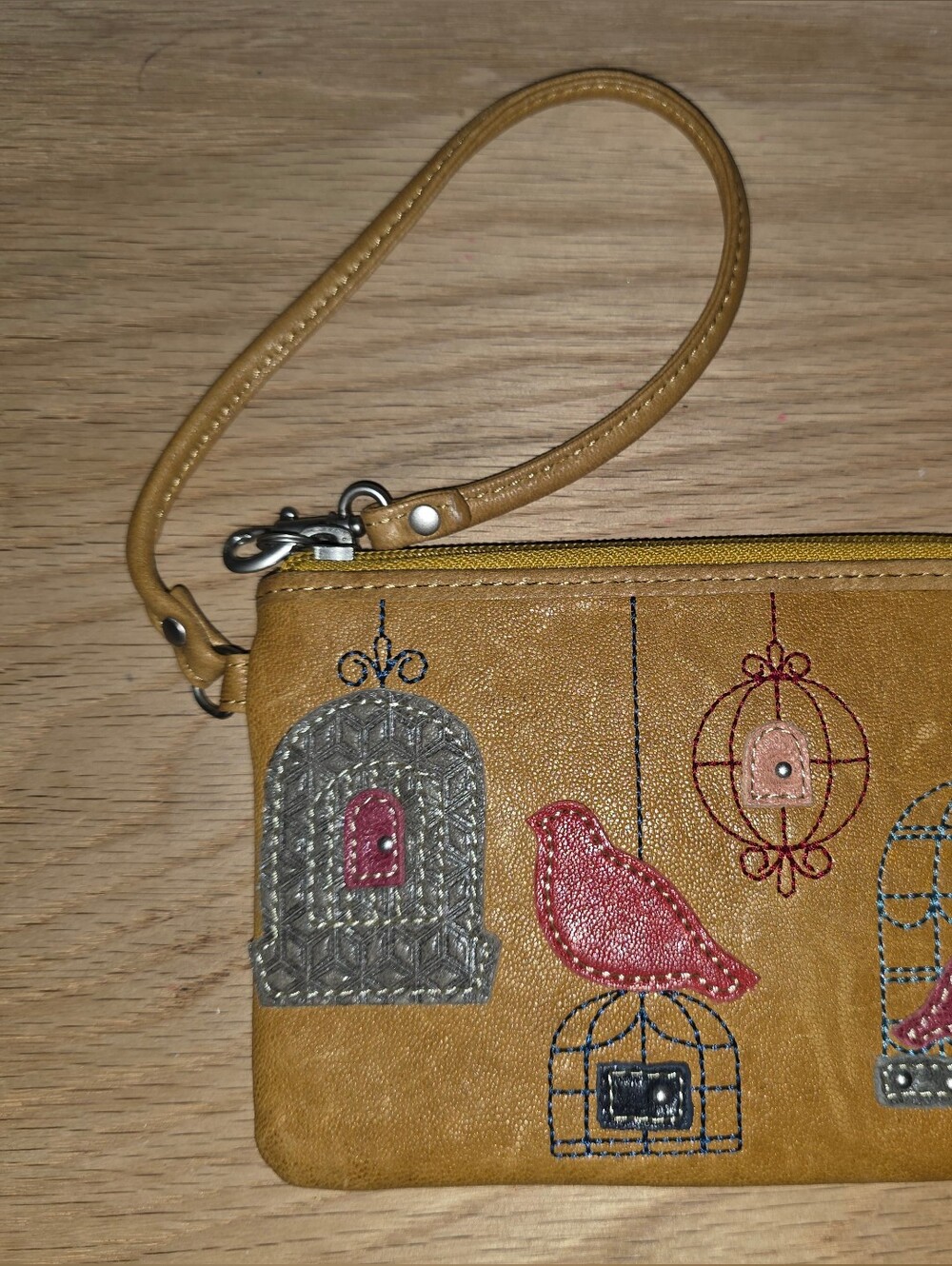 Fossil Mustard Yellow Wristlet with Embroidered Bird & Cage Motifs